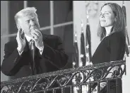  ?? Tasos Katopodis / Getty Images ?? President Donald Trump stands with newly sworn in U.S. Supreme Court Associate Justice Amy Coney Barrett on Monday during a ceremonial swearing-in event on the South Lawn of the White House. The Senate confirmed Barrett’s nomination to the Supreme Court by a vote of 52-48.
