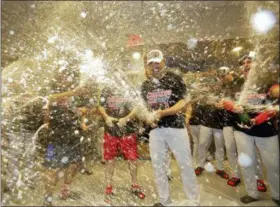  ?? FRANK FRANKLIN II — THE ASSOCIATED PRESS ?? The Boston Red Sox celebrate in the locker room after beating the New York Yankees 4-3 in Game 4 of the American League Division Series, Tuesday in New York. The Red Sox advanced to face the Houston Astros in the ALCS.