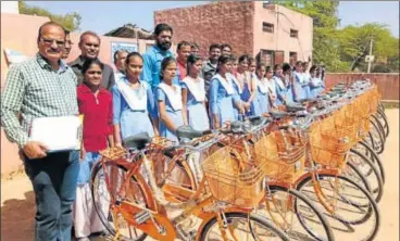  ?? HT PHOTO ?? To check the dropout rate, Class 9 students in Rajasthan were gifted orange cycles in February this year. The opposition termed the move as yet another attempt at saffronisa­tion of education in the state, which has already seen school and college...