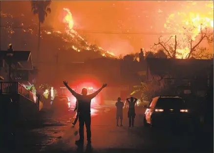  ?? Wally Skalij Los Angeles Times ?? RESIDENTS react as the 2017 Thomas fire burns above La Conchita. Five of the 10 largest fires in state history have come since 2010.