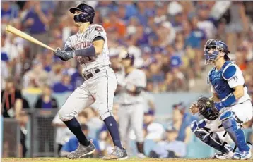  ?? CHRISTIAN PETERSEN/GETTY ?? Carlos Correa’s home run was one of three the Astros slugged during extra innings in Game 2 on Wednesday night.