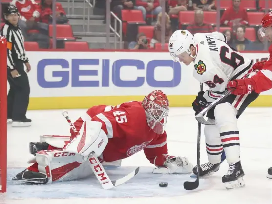  ??  ?? Red Wings goalie Jonathan Bernier makes a save against Blackhawks forward David Kampf during the first period of a preseason game Thursday in Detroit.