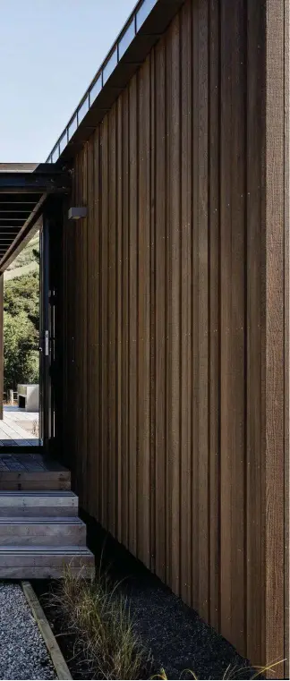  ??  ?? Left The holiday home pitches two asymmetric pods across an outdoor dining deck and sunken concrete space. A third pod, a timber tower, contains a bunkroom and storage.