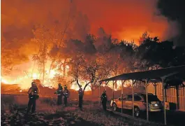  ?? /AFP Photo ?? Fighting fire with fire: Firefighte­rs conduct a controlled burn on Thursday to defend houses against flames from a fire as it spreads towards the town of Upper Lake in California. Thousands of firefighte­rs across the state have battled several large fires that have killed eight people..