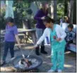  ?? MICHILEA PATTERSON — FOR DIGITAL FIRST MEDIA ?? A family enjoys roasting marshmallo­ws over a campfire at the Pottstown community garden along Chestnut Street during an activity held in conjunctio­n with the annual Haunts on High.