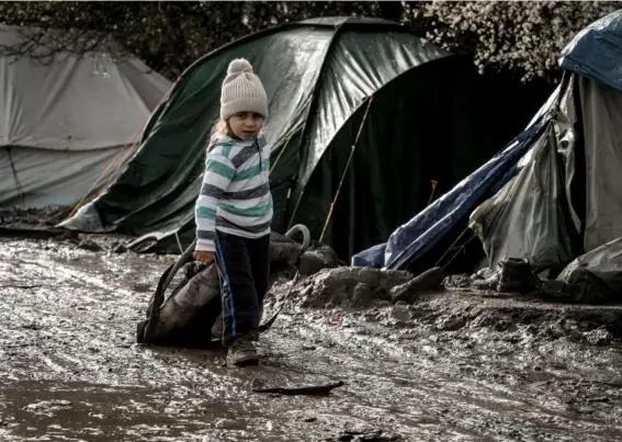  ??  ?? Unaccompan­ied refugee children walk among the shelters at the Jungle camp at Calais (Getty)