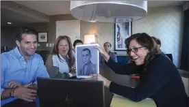  ?? BRITTAINY NEWMAN / AP ?? Anna Salton Eisen holds up a photo of Emil Ringel, father of Barbara Ringel, for a Zoom video call during a gathering for families of Holocaust survivors in East Brunswick, N.J.