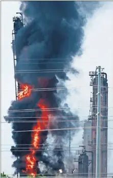  ??  ?? Flames and smoke rise Wednesday after a fire started at an Exxon Mobil facility in Baytown, Texas. [AP PHOTO]