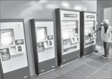  ??  ?? Worker checking the ticket dispensing machines for Sungai Buloh-Kajang MRT Line 1 before the opening for the public on Dec 16. — Bernama photo