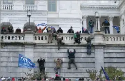  ?? JOSE LUIS MAGANA — THE ASSOCIATED PRESS FILE ?? Violent insurrecti­onists loyal to President Donald Trump scale the west wall of the U.S. Capitol in Washington on Jan. 6.