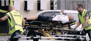  ?? | AP ?? AMBULANCE staff remove a man from outside a mosque in central Christchur­ch, New Zealand, yesterday.