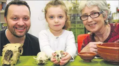  ?? Picture: Andy Payton FM4676176 ?? From left, Ben Ferris, Simone Ferris, four and Marion Green from Canterbury Archaeolog­ical Trust are hands on with some of the artefacts discovered by the trust