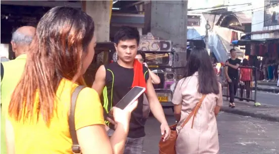  ?? AL PADILLA ?? Travel made easy Activities flourish underneath the Light Rail Transit Baclaran Terminal in Pasay City. The oldest mass transit system which was built during the era of former President Ferdinand Marcos will be extended up to Cavite City.