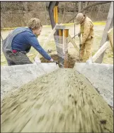  ?? NWA Democrat-Gazette/BEN GOFF ?? Corey Milford (left) and Eric Wolski with Milford Sign Co. pour cement March 7 for a new sign at Blowing Springs Park in Bella Vista. The sign will welcome visitors to the new Bella Vista Arboretum.