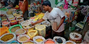  ?? AFP file ?? A shopkeeper selling pulses and other dried food items in Siliguri. —
