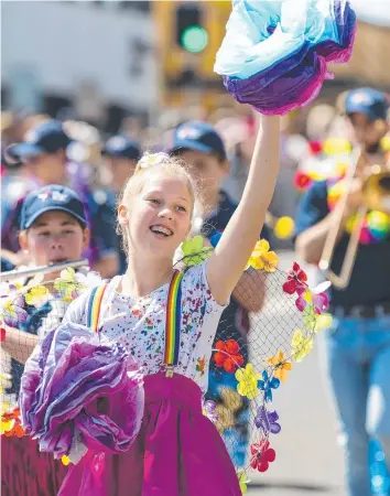  ?? Pictures: Kevin Farmer/Nev Madsen ?? FLOWERY: Emma Burton walks with the Mary MacKillop Catholic College float in the Carnival of Flowers floral parade.
