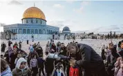  ?? Mahmoud Illean/Associated Press ?? A man observes the moon through a telescope next to the Dome of Rock Mosque at the Al-Aqsa Mosque compound in Jerusalem’s Old City, Sunday. Islamic officials look for the arrival of the crescent moon to determine the beginning of the holy fasting month of Ramadan.