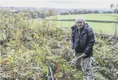  ??  ?? SHEAR JOY:David Wager clearing weeds, photo by Bruce Fitzgerald