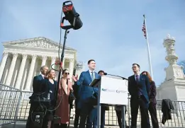  ?? ANDREW CABALLERO-REYNOLDS/GETTY-AFP ?? NetChoice Litigation Center Director Chris Marchese, center, speaks to reporters Monday near the U.S. Supreme Court in Washington.