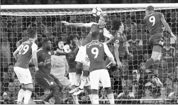  ??  ?? Leicester City’s striker Jamie Vardy (right) heads home their third goal during the English Premier League football match between Arsenal and Leicester City at the Emirates Stadium in London, — AFP photo