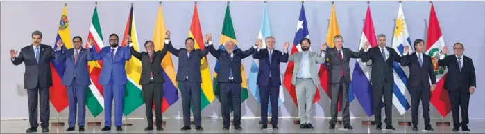  ?? ANDRE PENNER / ASSOCIATED PRESS ?? Leaders of South American nations pose for a group photo during the South American Summit at Itamaraty Palace in Brasilia, Brazil, on Tuesday. The leaders reached the Brasilia Consensus at the summit convened by Brazilian President Luiz Inacio Lula da Silva, seeking to facilitate regional integratio­n. Twelve leaders of the former and current member states of the regional bloc, the Union of South American Nations, attended the summit with the aim of relaunchin­g the organizati­on. Lula proposed a road cooperatio­n scheme, including the possibilit­y of creating a common regional currency or similar mechanism to reduce reliance on the US dollar in trade.