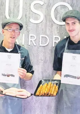  ??  ?? High five Fergusons of Airdrie shop manager Willie McMath (left) and butcher Liam Connor with two of its five award-winning products; the latter is holding the lamb grill sticks shortliste­d for a “best of the best” diamond accolade