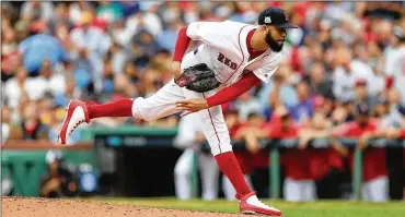  ?? ELSA / GETTY IMAGES ?? David Price delivers in a relief stint during the fourth inning to help beat Houston on Sunday in the AL playoff series. Boston avoided eliminatio­n, with Game 4 today and the Astros leading the best-of-5 series 2-1.