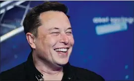  ?? Hannibal Hanschke Associated Press ?? JUST AS negative news was surfacing in China and Germany, Elon Musk announced Tesla had made a $1.5-billion investment in bitcoin starting in January.