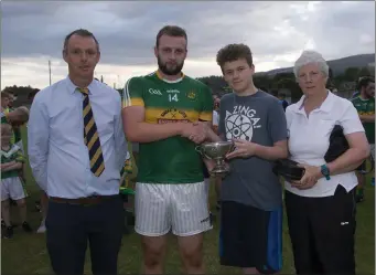  ??  ?? Danny Kavanagh receives the cup from Conal Tighe with Martin Fitzgerald and Mrs Fox.
