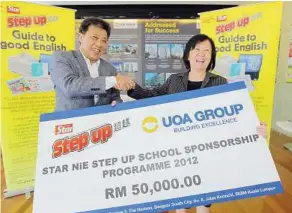  ??  ?? Generous sponsor: Wong (left) receiving a mock cheque from Chan at Menara UOA in Bangsar South yesterday.