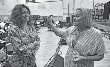  ?? AP ?? Director Cynthia Nekvasil, right, and musical director Camille Trust chat during a rehearsal for the touring show “Hits! The Musical.”