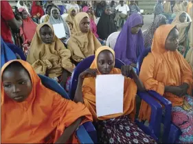  ?? PHOTO/HAMZA SULEIMAN ?? The girls from the Government Girls Science and Technical College Dapchi who were kidnapped and set free are photograph­ed during a hand over to government officials in Maiduguri, Nigeria, on Wednesday. Witnesses say Boko Haram militants have returned...