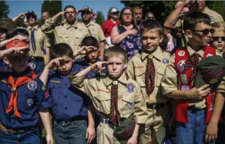  ?? JAKE MAY — THE FLINT JOURNAL - MLIVE.COM VIA AP ?? Boy Scouts and Cub Scouts salute during a Memorial Day ceremony in Linden, Mich. On Wednesday the Boy Scouts of America Board of Directors unanimousl­y approved to welcome girls into its Cub Scout program and to deliver a Scouting program for older...