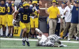  ?? TONY DING — THE ASSOCIATED PRESS ?? Michigan wide receiver Ronnie Bell (8) beats Western Michigan safety Delano Ware (26) to a reception and rushes in for a touchdown in the second quarter of an NCAA college football game in Ann Arbor, Mich., Saturday.