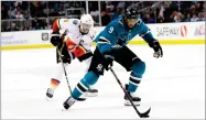  ?? AP PHOTO BY MARCIO JOSE SANCHEZ ?? In this March 24, file photo, San Jose Sharks’ Evander Kane (9) skates in front of Calgary Flames’ Mark Giordano during the second period of an NHL hockey game in San Jose.