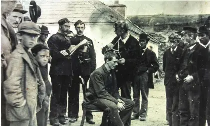  ?? Photograph: Trinity College Dublin ?? Academics measuring the heads of people on Inishbofin in 1892. It was believed at the time that the islanders were Ireland’s Indigenous people.