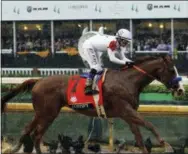  ?? GARRY JONES — THE ASSOCIATED PRESS ?? Mike Smith rides Justify to victory during the 144th running of the Kentucky Derby horse race at Churchill Downs Saturday in Louisville, Ky.