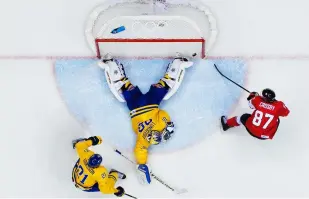  ??  ?? Above: This was the moment that Sweden lost the ice hockey final against Canada in the Sochi 2014 Winter Olympics. Joel placed cameras above each net because you can’t know at which side the game-winning goal will be. While he had planned to capture the game-winning shot, you still need to be lucky; other photograph­ers had cameras in the same position, but they didn’t capture the puck crossing the goal line.