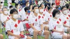  ?? AP PHOTO ?? Olympic torchbeare­rs wearing face masks sit and wait for their turn in Kanazawa .