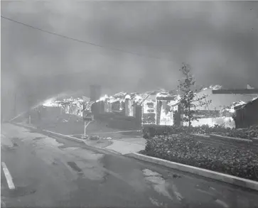  ?? George Fry Los Angeles Times ?? A PHOTO published on the front page of the Nov. 7, 1961, edition of the Los Angeles Times shows homes burning on Roscomare Road in Bel-Air. A fire that erupted Wednesday threatened houses in the same area.