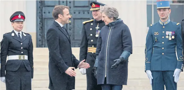  ?? Pictures: STEFAN ROUSSEAU / PA ?? President Emmanuel Macron and Prime Minister Theresa May stand with British and French service personnel at Sandhurst Military Academy, Berkshire, yesterday