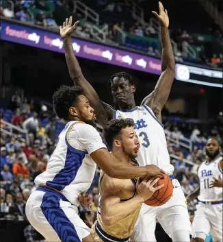  ?? CHRIS CARLSON/ASSOCIATED PRESS ?? Tech guard Lance Terry drives between Pittsburgh guard Nelly Cummings (left) and center Federiko Federiko during the first half of an ACC Tournament second-round game Wednesday in Greensboro, N.C.
