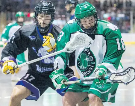  ?? DARREN STONE, TIMES COLONIST ?? Shamrocks forward Steve Higgs fends off Jake Taylor of the Thunder during WLA action at The Q Centre on Friday.