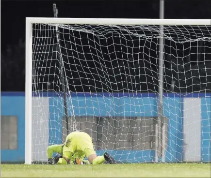  ?? Rebecca Blackwell ?? The Associated Press U.S. goalkeeper Tim Howard kneels in the goal area after being scored upon by Trinidad and Tobago during a World Cup qualifying match on Tuesday night in Couva, Trinidad and Tobago. The Americans lost 2-1 and failed to make next...