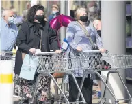  ??  ?? PREPARED Shoppers set to hit the supermarke­t yesterday