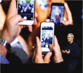  ??  ?? SAN FRANCISCO: In this Sept 7, 2016, file photo, Apple CEO Tim Cook announces the new iPhone 7 during an event to announce new products, in San Francisco.— AP