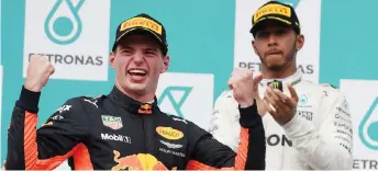  ?? — AFP photo ?? File photo shows Verstappen reacts on the podium in front of Hamilton.