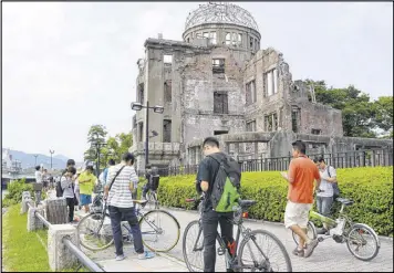  ?? KYODO NEWS ?? Several participan­ts in “Pokemon Go” descend on the Atomic Bomb Dome at Hiroshima Peace Memorial Park in Hiroshima, Japan.