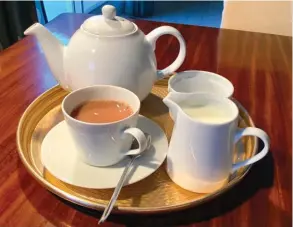  ??  ?? A FILLED tea tray with the essential elements: teapot, cup and saucer, teaspoon, milk jug and sugar bowl.