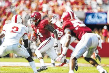  ??  ?? Alabama defensive back Eddie Jackson looks for an opening after intercepti­ng a pass during Saturday’s game against Western Kentucky in Tuscaloosa. The Crimson Tide won 38-10, but coach Nick Saban was disappoint­ed by his team’s performanc­e.